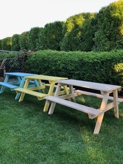 Coronation Montessori 3 picnic tables outside in different colors