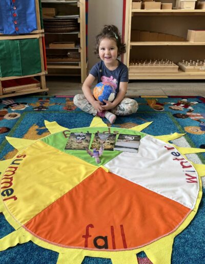 Montessori young girl with circle for seasons