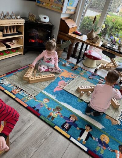 Coronation Montessori on carpet with wooden toys