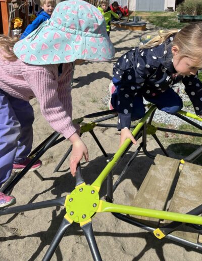 Montessori children climbing on tube structure